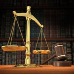 Scales of justice and gavel on desk with dark background that allows for copyspace. ? via FTP